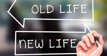 Man hand writing Old Life or New Life on visual screen. Business, help, internet, technology concept.